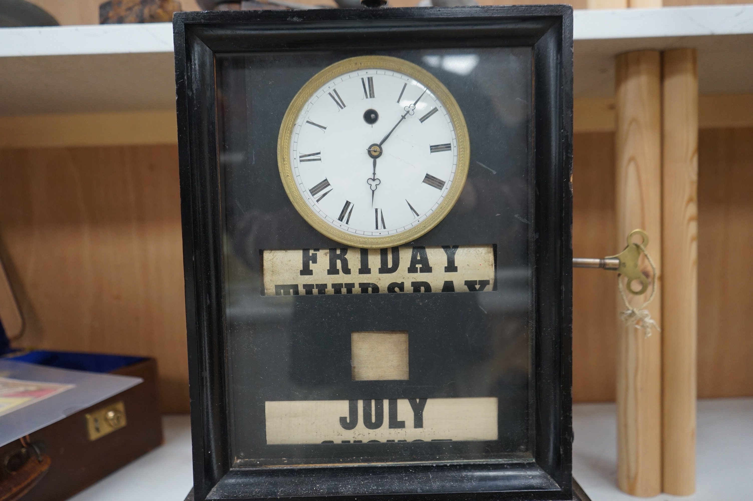 A 19th century ebonised mantel clock combined perpetual calendar with key, 43cm high. Condition - fair, untested